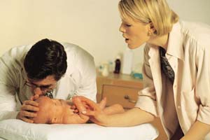doctor and nurse examining baby