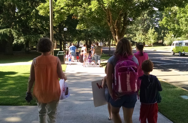 Children and their teachers walk down a sidewalk on the WOU campus