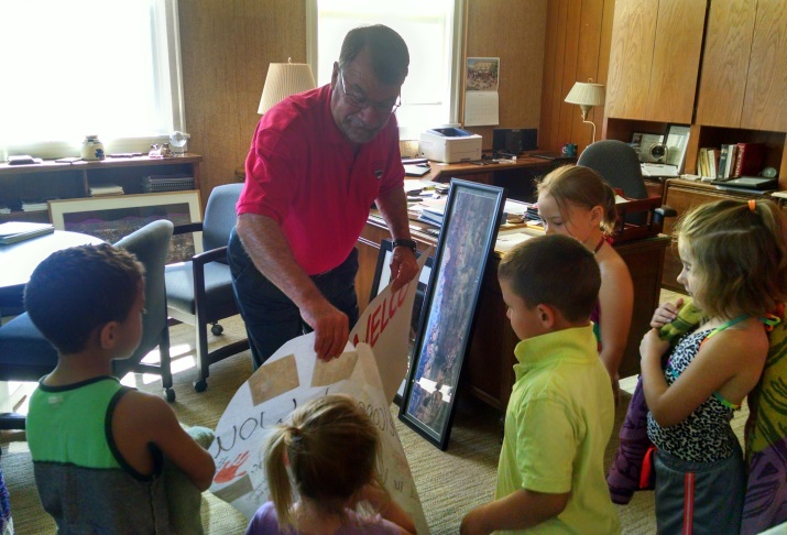 The CDC children give handmade "Welcome" signs to President Fuller