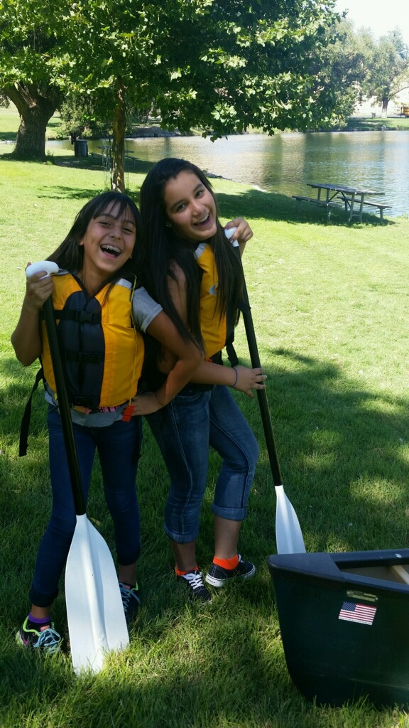two girls holding paddles