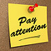Post It not on a cork board that reads - Pay Attention