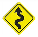 A yellow street sign indicating curving roads