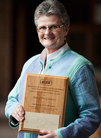 Betsy McGinnity holding award